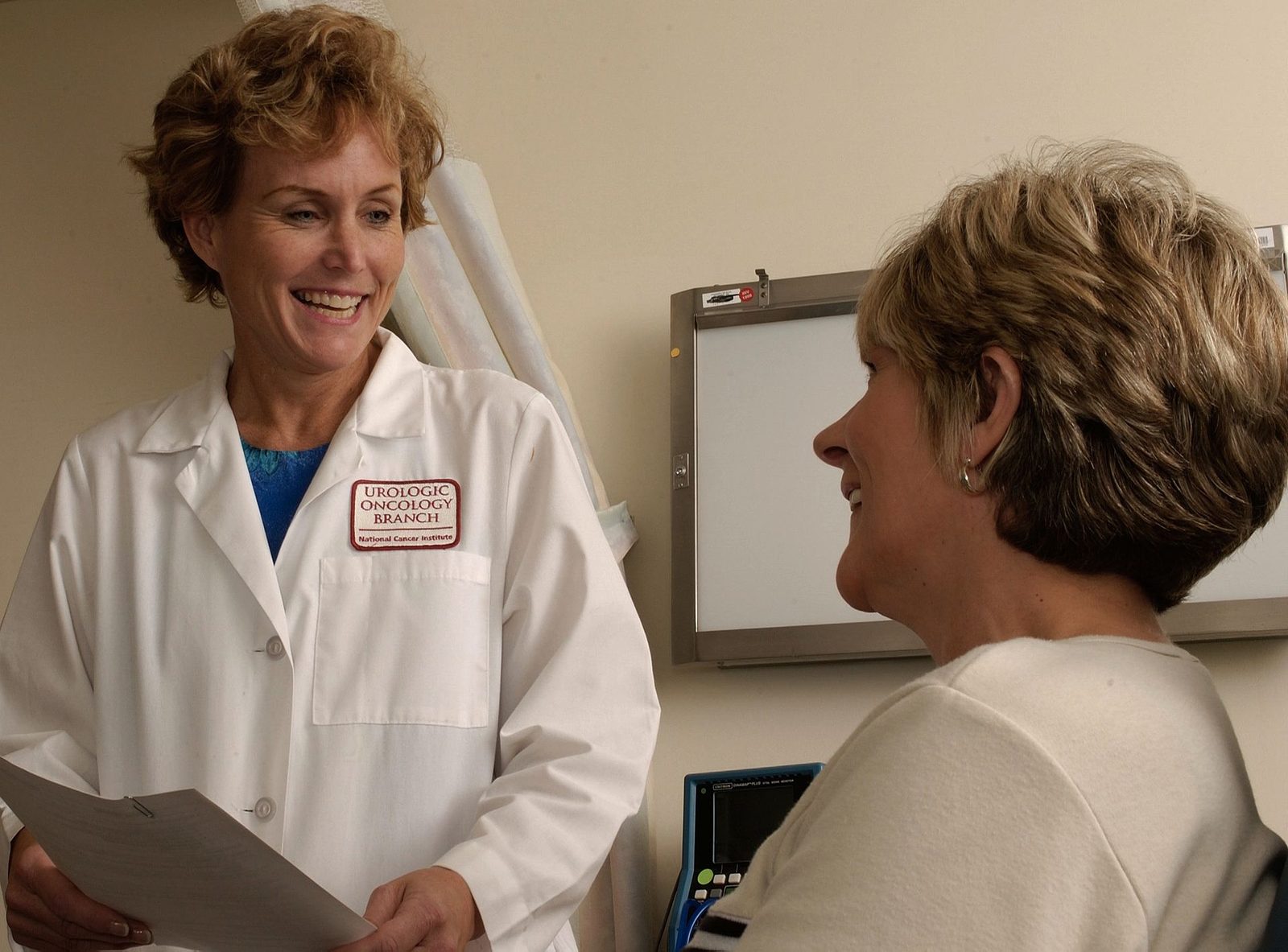 Clinician in conversation with a patient during a consultation.